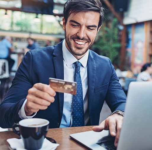 smiling man with credit card