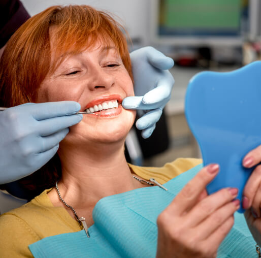 woman at the dentist looking at smile